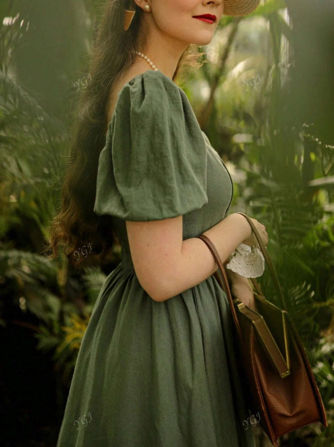 Green dress with puffed sleeves and Queen Anne neckline