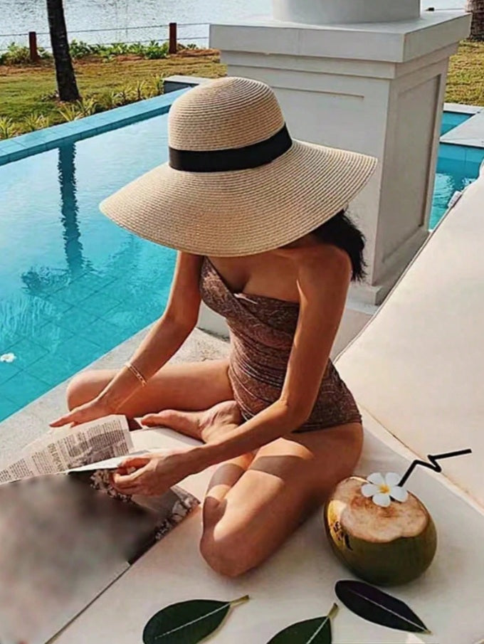 Large floppy hat with black ribbon